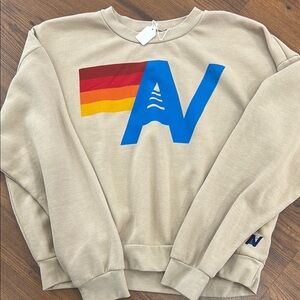 Beige Sweater with Blue and Red Accents